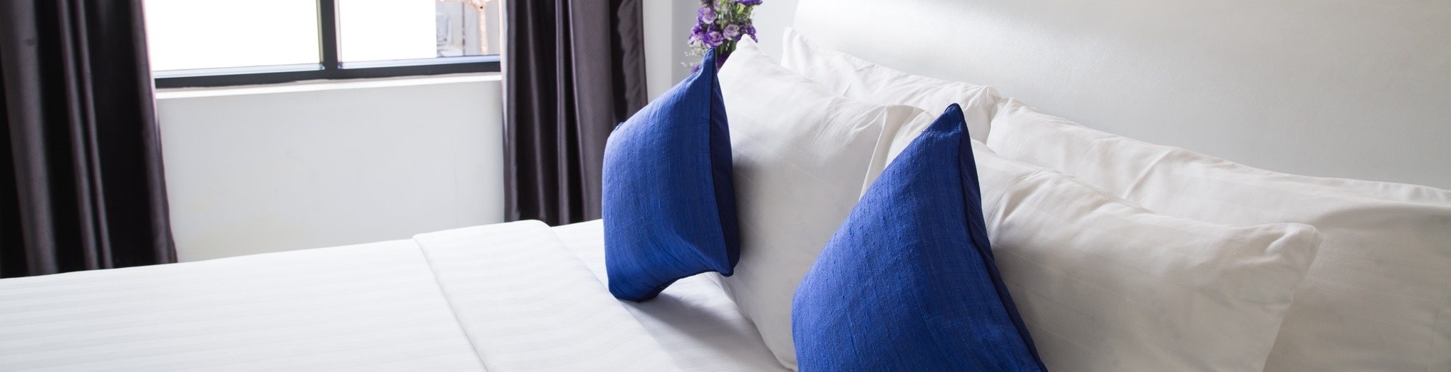 bed blue pillows hero